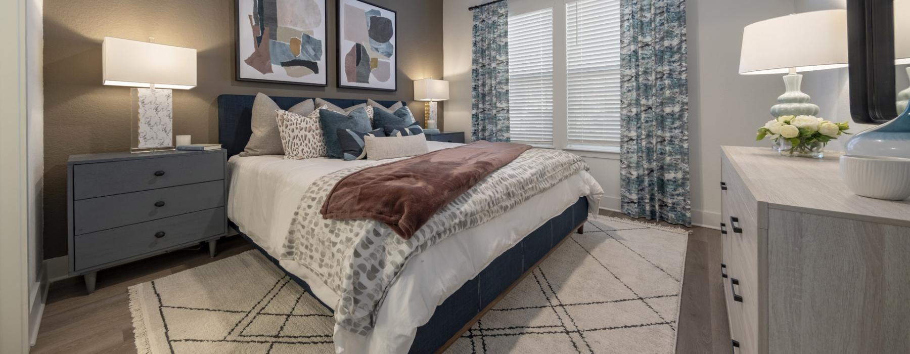 a bedroom with a bed and lamps